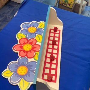 White wooden daisy shelf.
